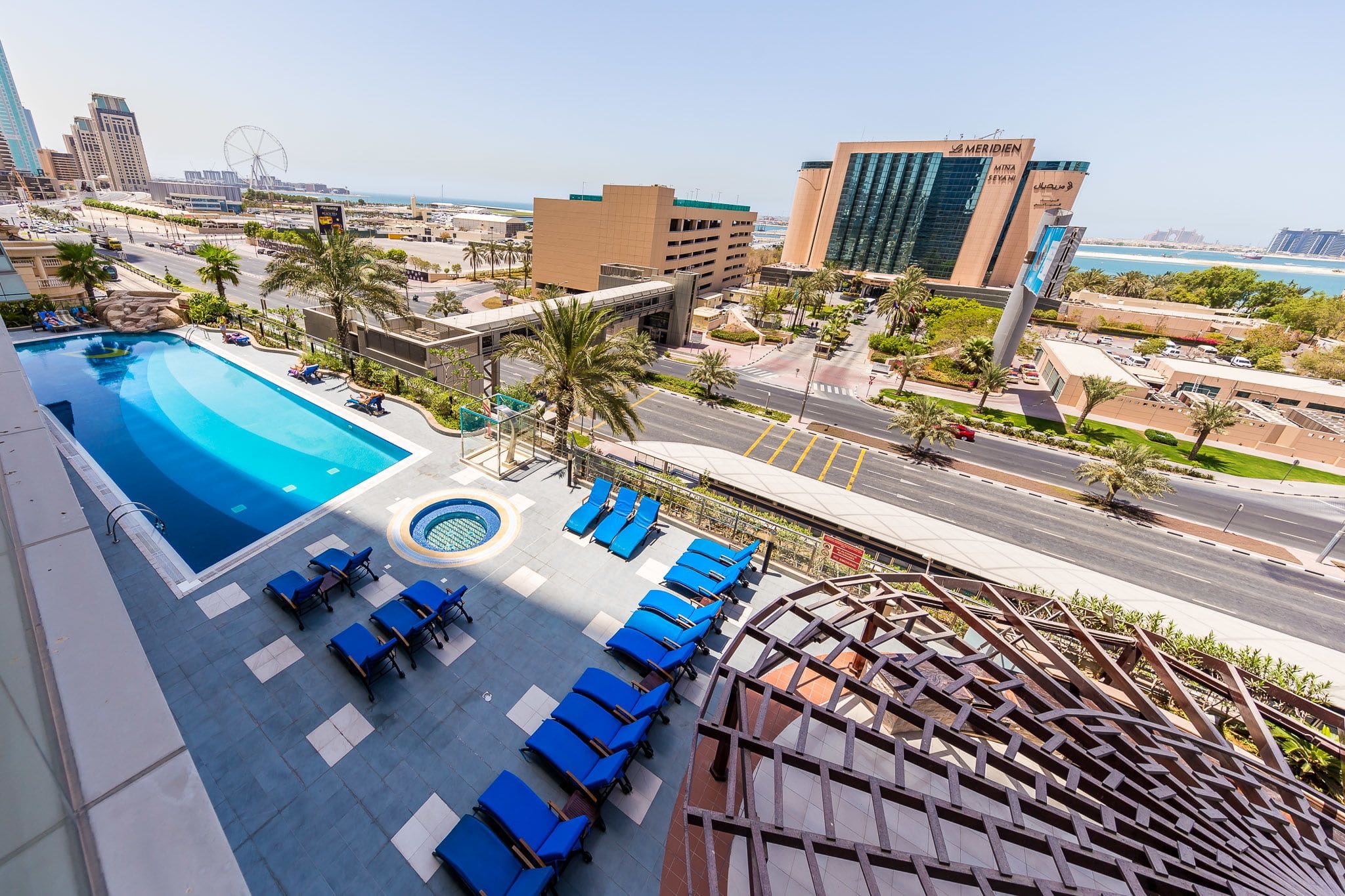 Ocean Heights pool terrace overlooking the road, pedestrian bridge and Mina Seyahi surroundings